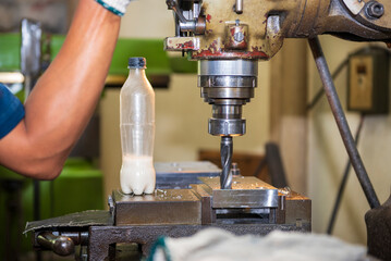 The machine operator working t NC milling machine.