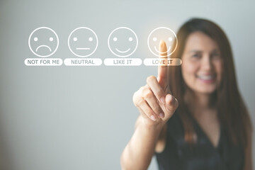 Customer review good rating concept hand pressing smile face icon on visual screen for the positive...