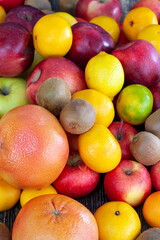 a bunch of citrus tangerines and other fruits together