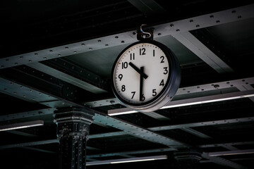 Old vintage style clock on a railway station