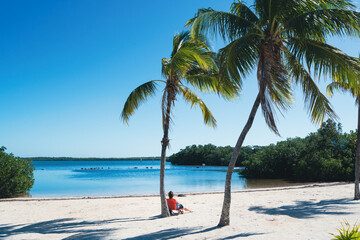 Woman sunbathing on beach at John Pennekamp state park in Key Largo, Florida
