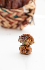 dates in a basket made of palm fronds with a white background in a basket made of palm fronds with a white background- Eid Mubarak - Ramadan
