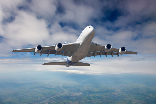 The passenger plane in flight. Aircraft climb into the blue sky above the clouds. Front view of aircraft.