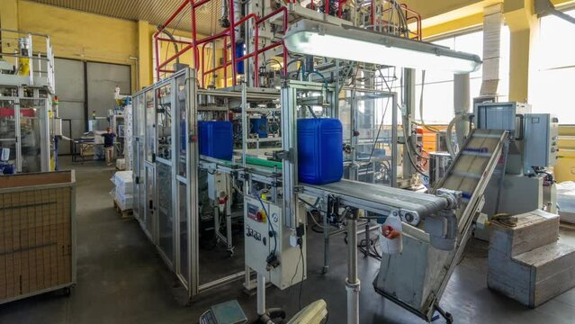 A factory for plastic canister production timelapse hyperlapse. The conveyor in the factory.