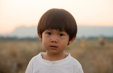 Little asian boy looking at camera