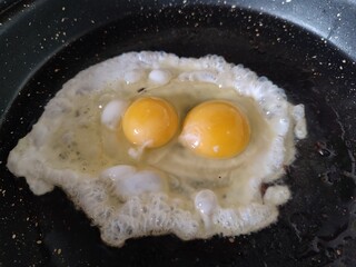 fried eggs in a frying pan