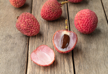 Lychees cut fruit over wooden table