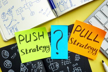 Push or pull strategy in marketing. Notepads and keyboard.