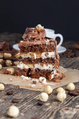 a piece of cake made of chocolate sponge cake cream and caramel with hazelnuts