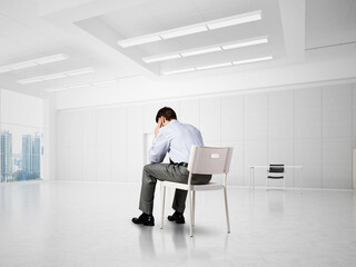 young businessman on chair in office