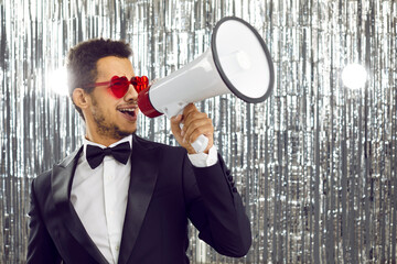 Declaration of love with megaphone. Funny handsome young dark skinned man in suit using loudspeaker...