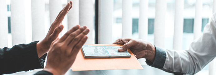 Businessmen give dollars to bribe employees in signing contracts to buy illegal land and real estate, Business fraud and social injustice, Anti Bribery and corruption concept.
