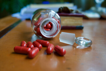 Red capsules and pharmacy glass bottle