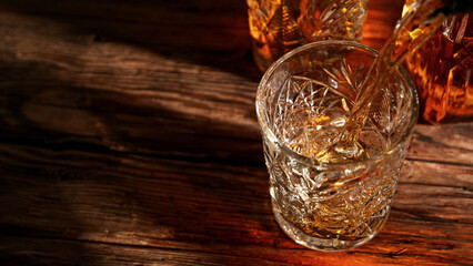 Detail of pouring whisky into glass.