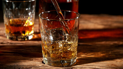 Detail of pouring whisky into glass.