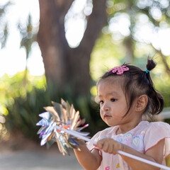 Asian girl playing wind turbine