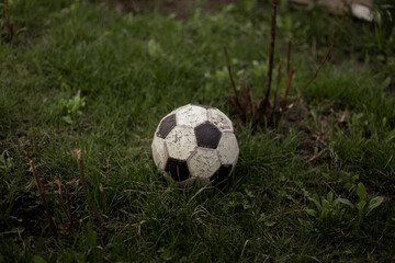 Fototapeta premium Old soccer ball on soccer field.