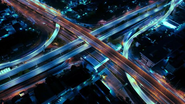 Expressway top view, Road traffic an important infrastructure,car traffic transportation above intersection road in city night, aerial view cityscape of advanced innovation, financial technology