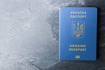 Passport of a citizen of Ukraine  on a dark background, close-up. Inscription in Ukrainian Ukraine Passport