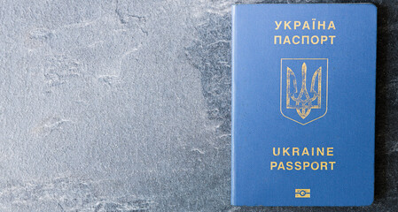 Passport of a citizen of Ukraine  on a dark background, close-up. Inscription in Ukrainian Ukraine Passport