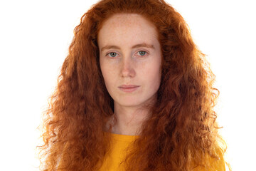 Pensive freckled girl with ginger hair, wearing orange t-shirt