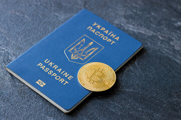 Crypto currency bitcoin lies on the passport of Ukraine on a blue background. The concept of business, mining, earnings in Ukraine.