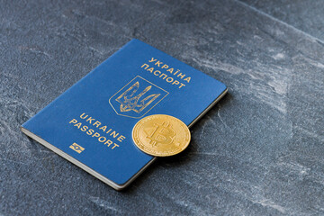 Crypto currency bitcoin lies on the passport of Ukraine on a blue background. The concept of business, mining, earnings in Ukraine.
