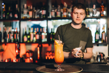 Vintage portrait of bartender creating cocktails at bar. Close up of alcoholic beverage preparation