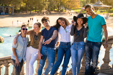 Fototapeta premium Group of young multiracial students smiling to the camera on some stairs