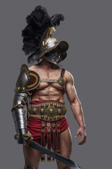 Fototapeta premium Portrait of handsome ancient rome gladiator wielding sword with naked torso.