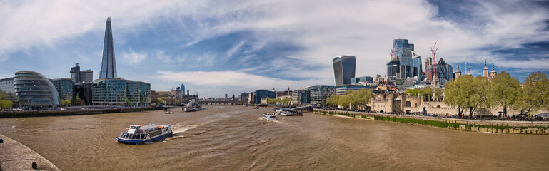 London, UK - April 20, 2022: Panoramic view over the river Thames in London from Tower Bridge. South bank and North bank, with the City of London.