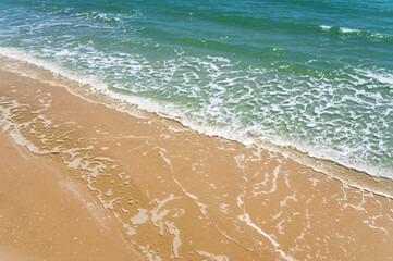 Above view of soft wave on sandy beach seaside. summer vacation activity  background concept.