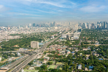 Metro Manila, Philippines - The SLEX Skyway going towards the Metro Manila cityscape and skyline. - obrazy, fototapety, plakaty