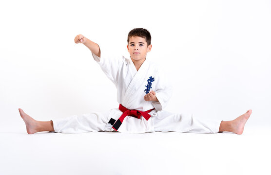 Karate Kid Stretching And Raising Fist On A White Background. Which Means: The Last Truth Associated.