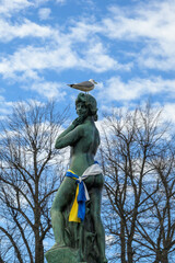 Havis Amanda statue near Helsinki market square having colours of the flags of Ukraine and Finland