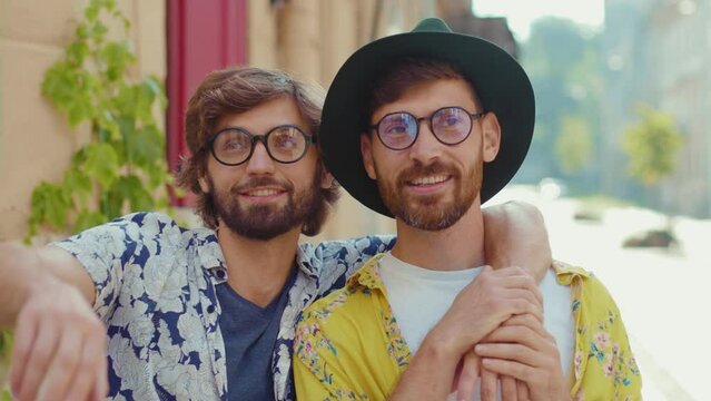 Cute portrait young two gay men with glasses look to side lovely feel happy homosexual couple dating LGBT relationship love smiling outdoors boyfriend attractive slow motion