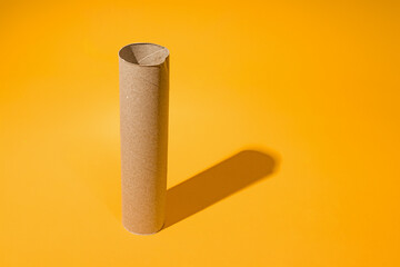 empty paper tube on yellow background