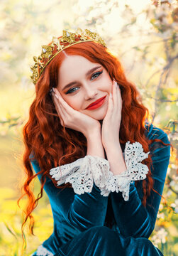 Close-up portrait happy red-haired woman queen in golden crown on head looking at camera. Girl joyful cheerful princess smiling face, green renaissance victorian dress. Red lips pale skin long hair
