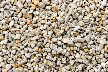 Background of small white sea stones. rocky surface