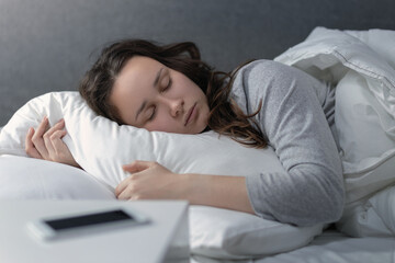 young woman sleeping in bed early in the morning, get enough sleep, daily routine, get up late
