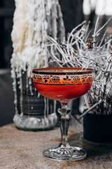 beautiful delicious orange cocktail in an elegant glass on a silver tray different beautiful cocktails in warm colors on a dark background. cocktail or bar menu concept.