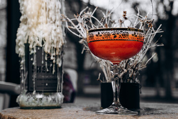 beautiful delicious orange cocktail in an elegant glass on a silver tray different beautiful cocktails in warm colors on a dark background. cocktail or bar menu concept.