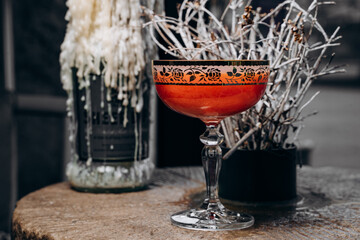 beautiful delicious orange cocktail in an elegant glass on a silver tray different beautiful cocktails in warm colors on a dark background. cocktail or bar menu concept.