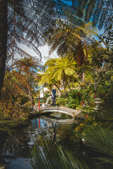Young and traveler walks in the Chinese section of the gardens of the monte palace madeira in the...