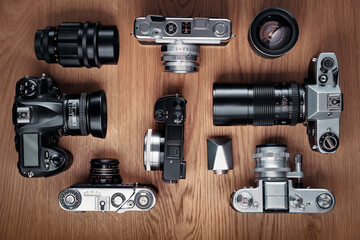 Vintage film cameras on wooden background.