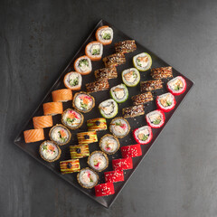 Sushi set. Roll with fresh ingredients on stone background. Top view.