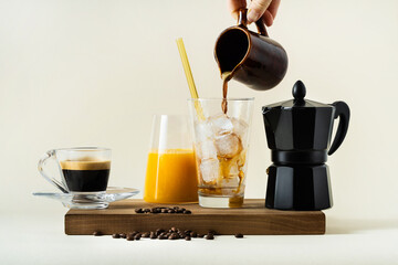 morning coffee concept: espresso, coffee with ice and milk and orange juice, italian coffee maker