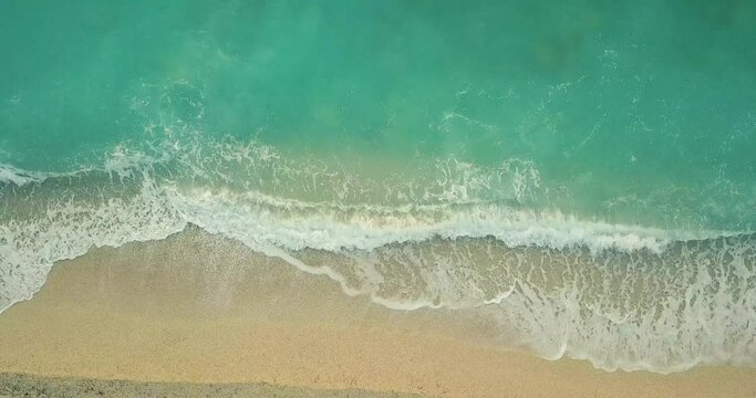 Aerial view of the amazing idyllic beach with waved sea.