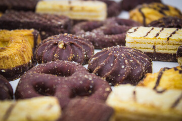 Chocolate biscuits and waffles on light background