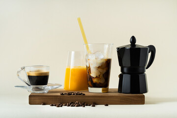 morning coffee concept: espresso, coffee with ice and milk and orange juice, italian coffee maker